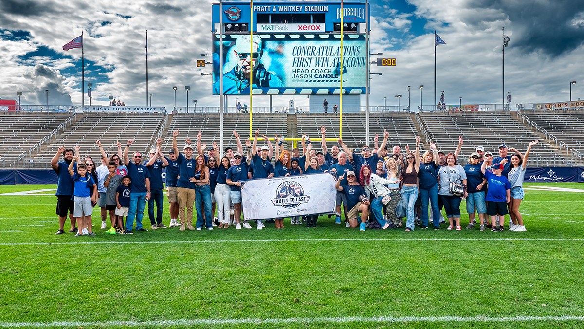Post-game group photo with the veteran family and the Built to Last banner